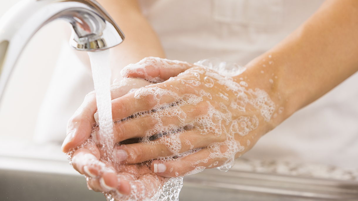 washing hands with soap under facuet