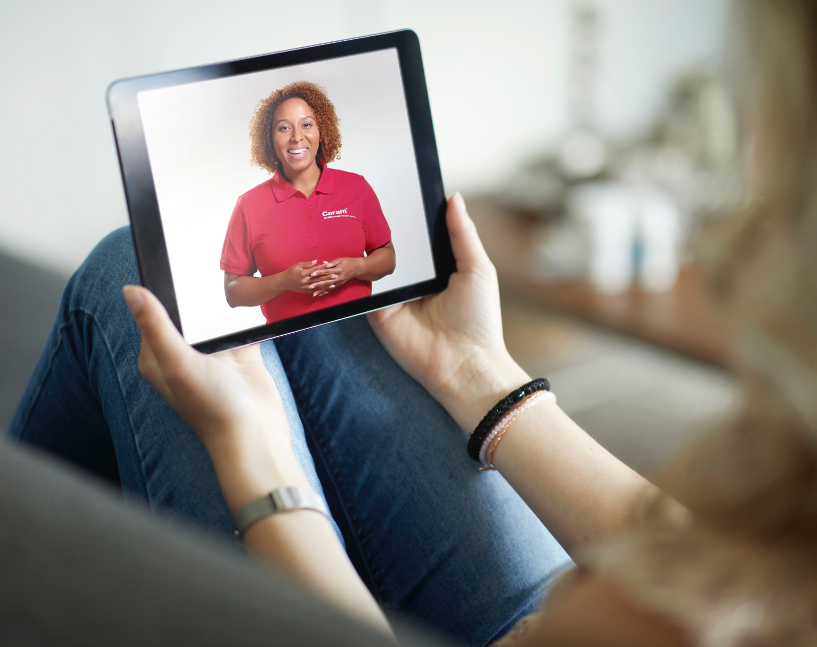 A patient talks with a Coram representative on their tablet