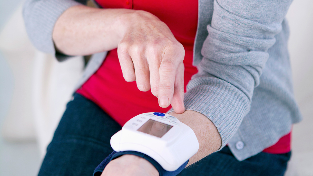 Woman checking monitor on wrist