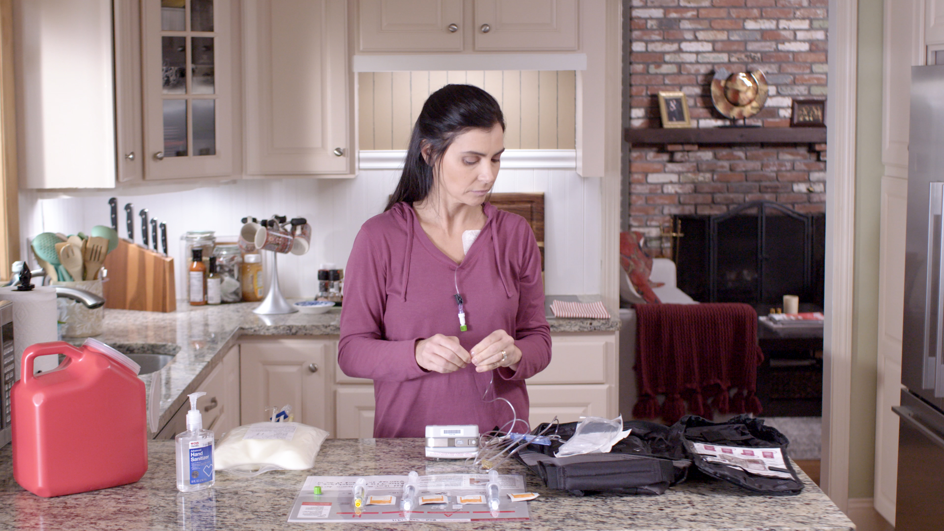 woman in kitchen setting up her tube feeding therapy