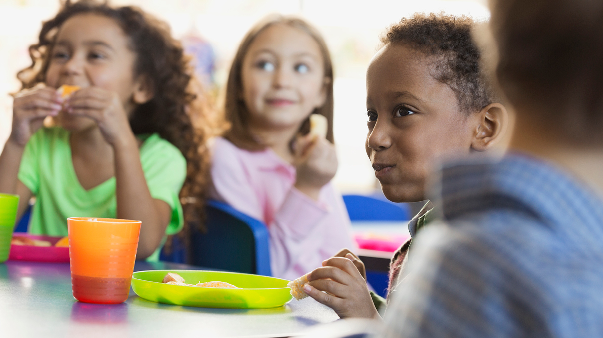 Children eating snacks in classroom