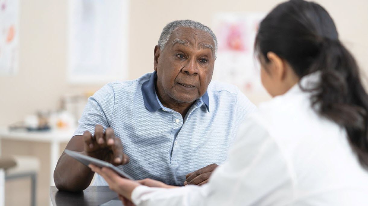 Man speaking with doctor