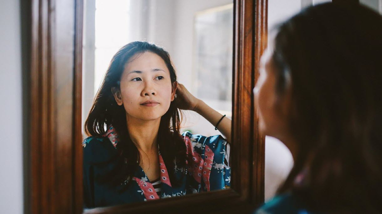 Woman looking in mirror