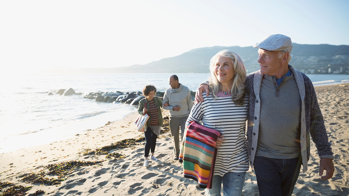 Two couples walking on the beach