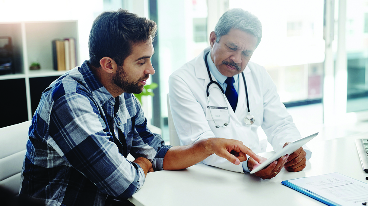 Provider showing information on tablet with patient